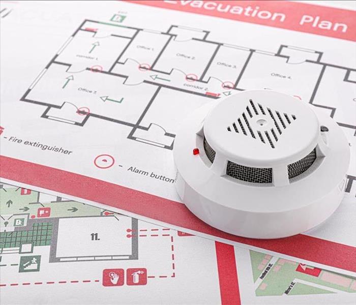 smoke detector on top of fire evacuation map